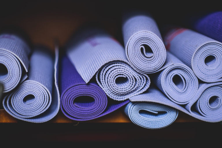 Rolled up purple yoga mats