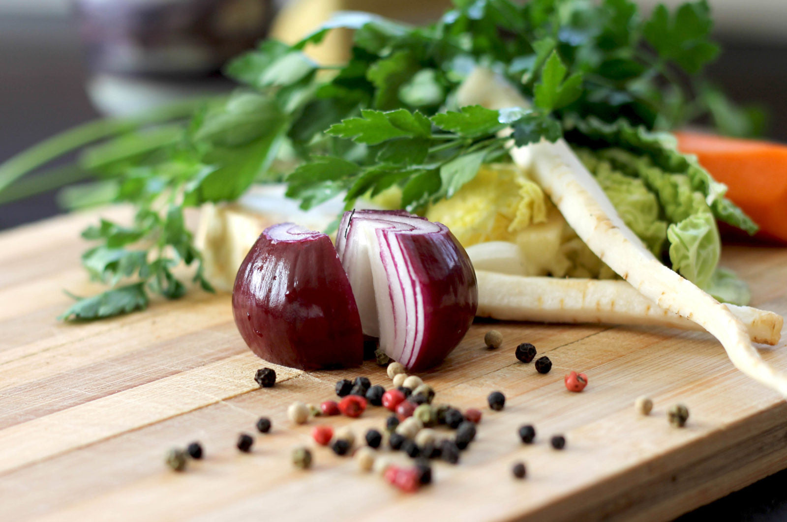 Cutting board with veggies and peppercorns