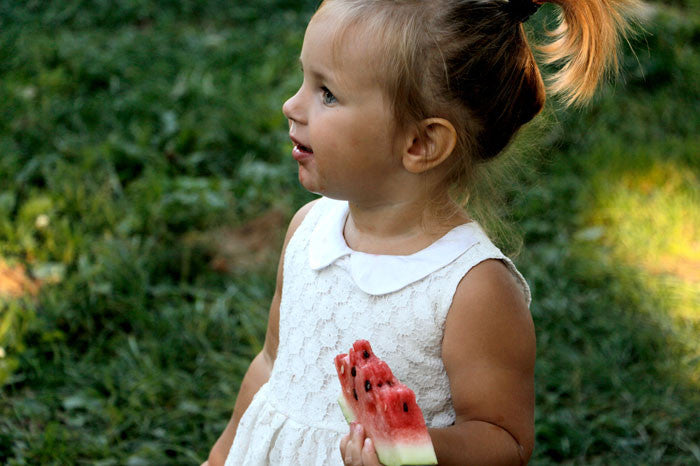 Little girl eating watermelon 