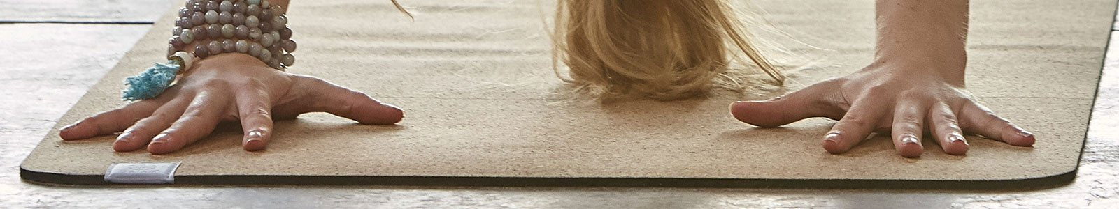 woman in downward dog on cork yoga mat