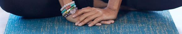 Woman's hands on her yoga mat