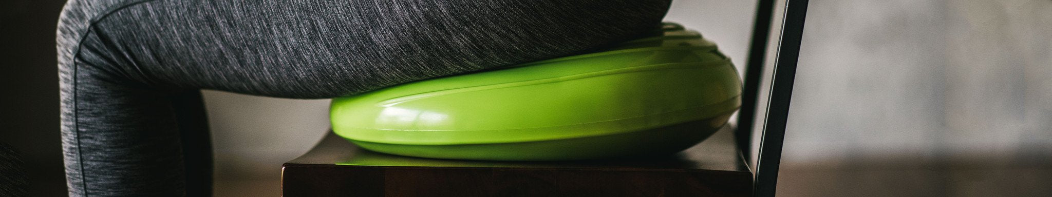 person sitting on balance disc
