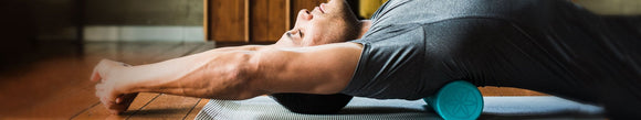 man stretching on foam roller
