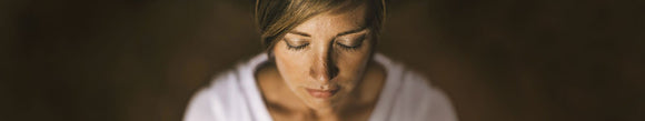 Woman's face with eyes closed looking peaceful.