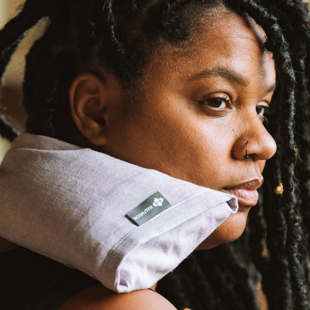 Halfmoon Hot + Cold Therapy Pillow Iris on woman's shoulders