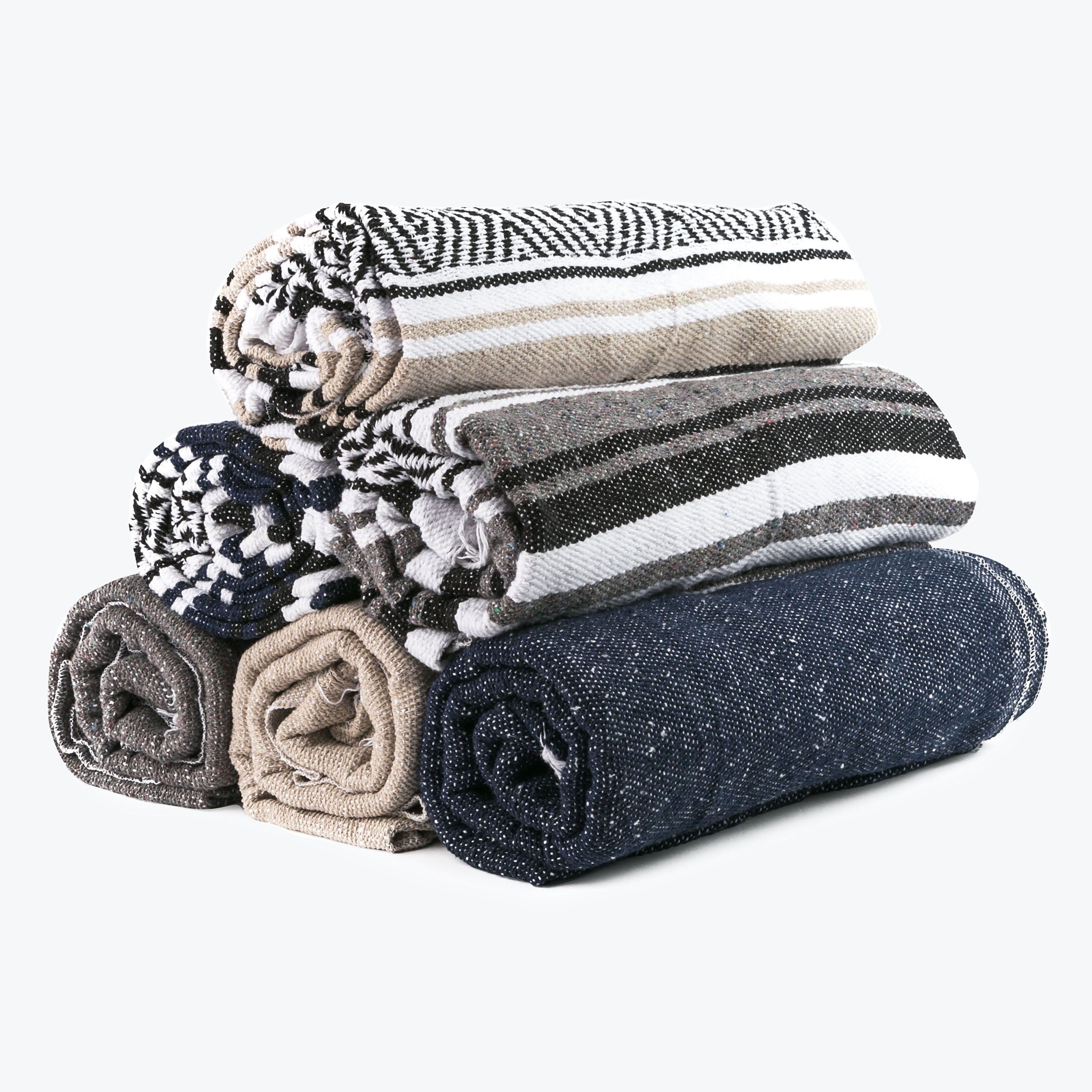Meditation Hardware Woven Blankets in all colors stacked on top of each other